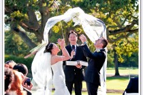 The bride and groom release 2 white balloons