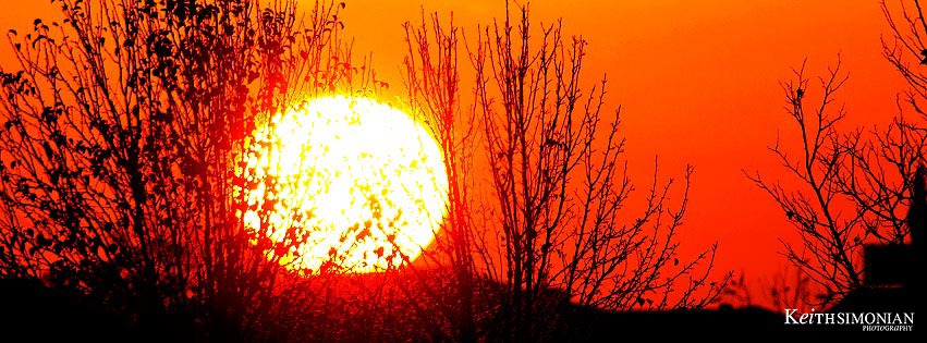 Blazing winter morning sun against red sky - free timeline cover image