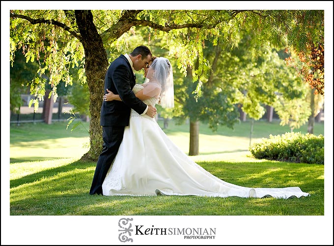 Bride and groom in shade of trees at Discovery Bay country club