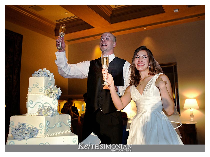 Cassie and Ben make a toast before cutting the 5 tier wedding cake
