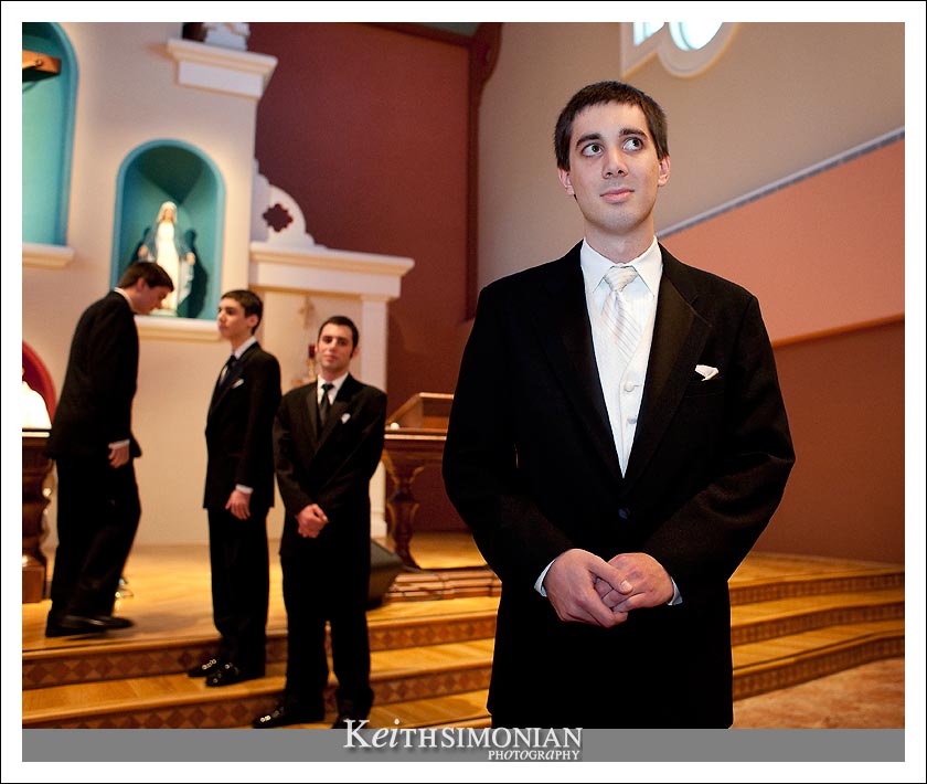 Nathan waits for Bridgett to be escorted up the aisle by her mother and father