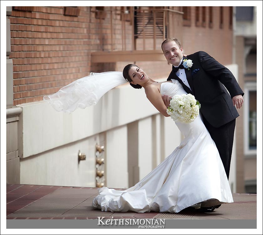 Groom dipping bride on the streets of San Francisco