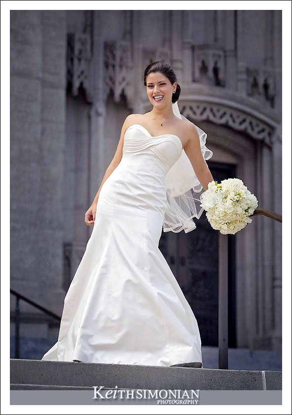 The bride on the stairs in front of Grace Cathedral Episcopal church