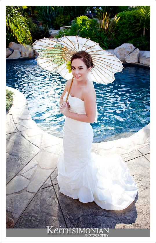 A Bride, a swimming pool, and an umbrella photo