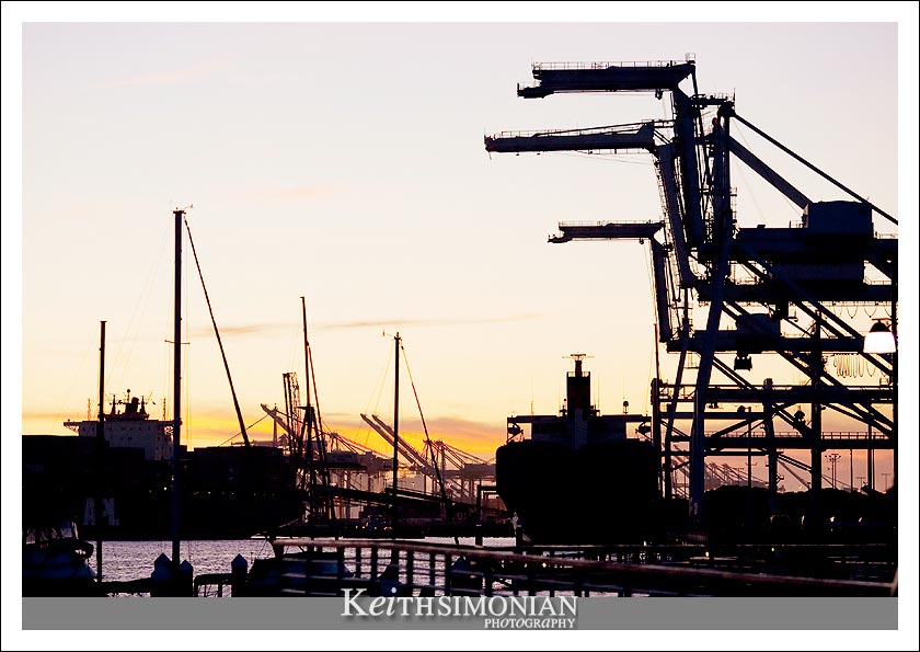 Sunset photo of the giant cranes that unload ships at the Port of Oakland