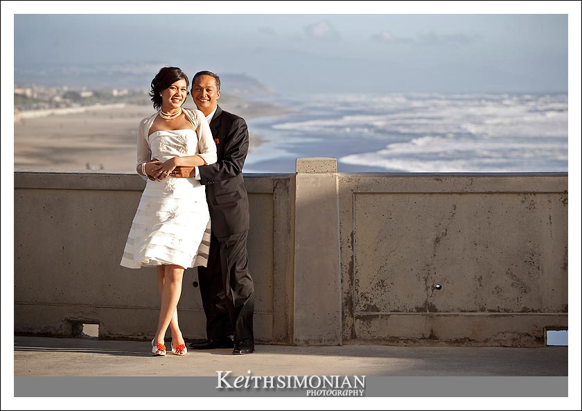 View of Pacific Ocean and bride and groom