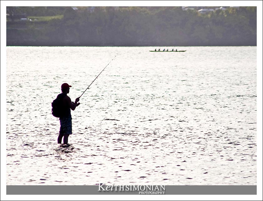 Angler in the shallow water of Kona Beach, Hawaii