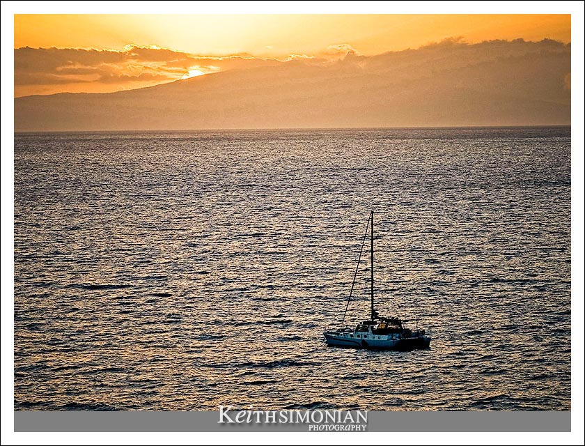 15-May-2005: Maui, Hawaii. A catamaran boat sits of the Maui shote during sunset.