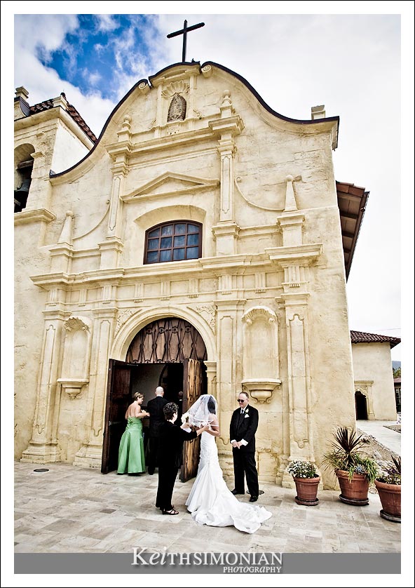 The bride with her father about to enter San Carlos Cathedral in Monterey for her wedding
