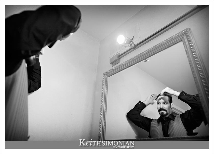 Black and White photo of groom getting ready
