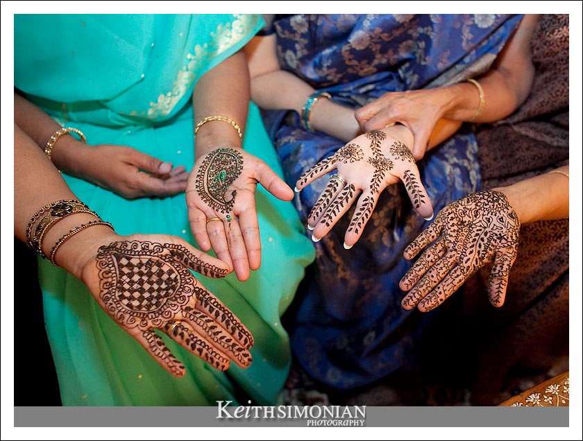 Four different guests at the Mehndi gathering show their painted hands