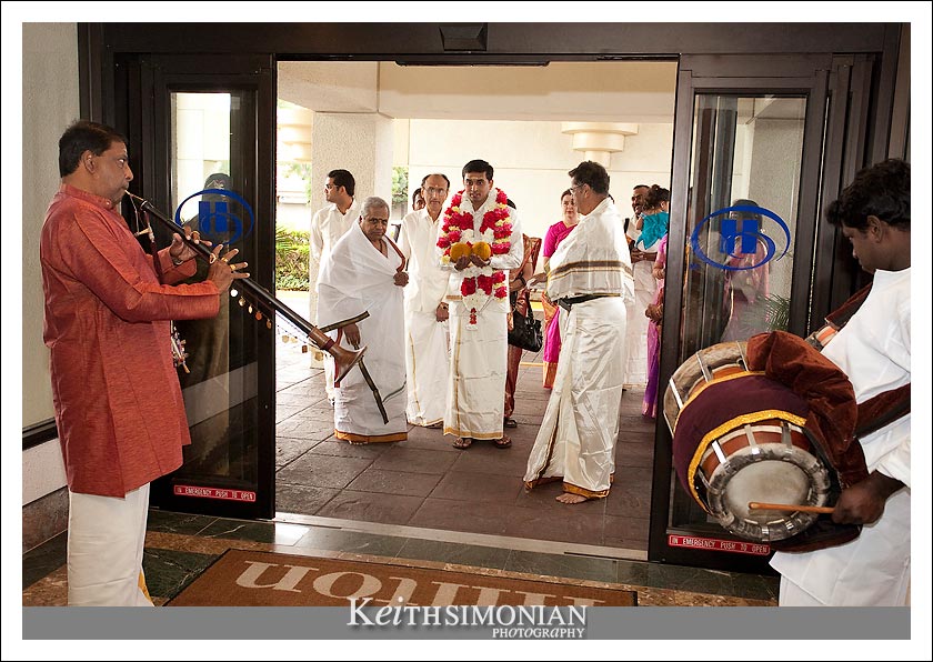 Groom enters the hotel to begin the swing ceremony