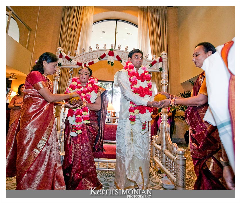 Family members help during the swing ceremony of Indian wedding