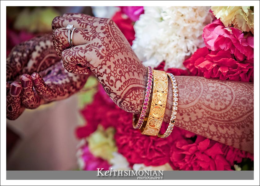 Henna skin decorations and gold jewelery adorn the bride