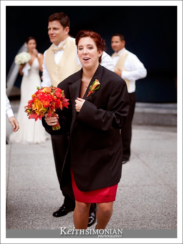 With a chill in the air, one of the bridesmaids wears a groomsmen's tux jacket