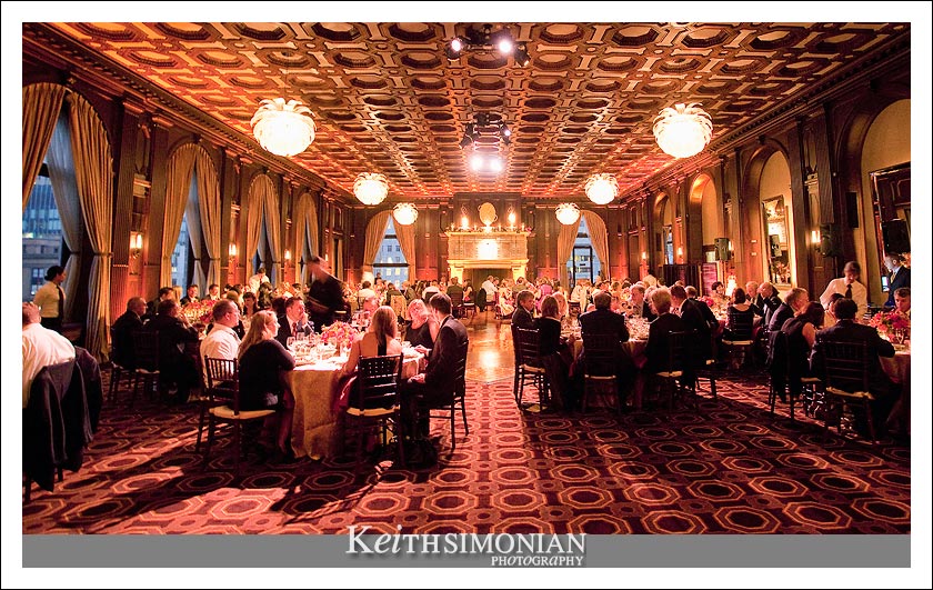 Wide angle photo of the wedding reception in the Julia Morgan Ballroom in the Merchants Exchange building in San Francisco California