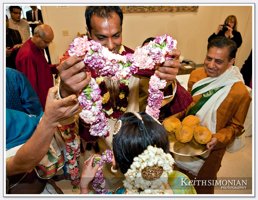 During the exhange of garlands ( Malai Matral ) the bridegroom places the colorful garland on the Bride at the Shiva-Vishnu Temple in Livermore, California