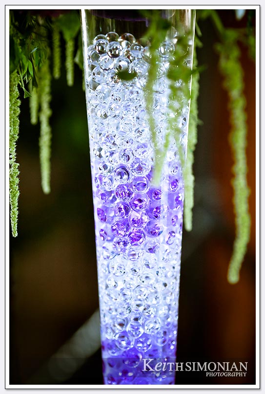 As a decoration a vase is filled with clear and purple marbles for all the reception guests to see at the Castlewood Country Club in Pleasanton, California
