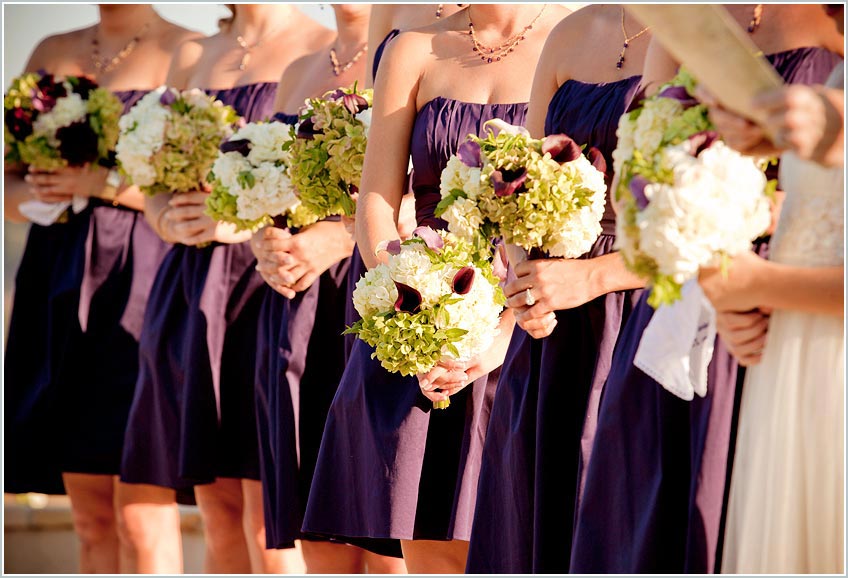 Purple dresses and bridesmaids flowers