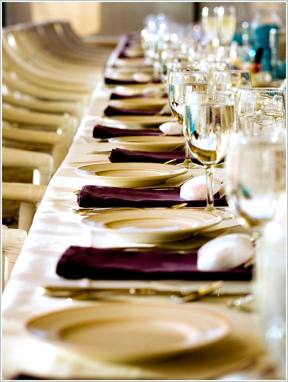 Plates and glasses await the wedding reception guests at Discovery Bay country club