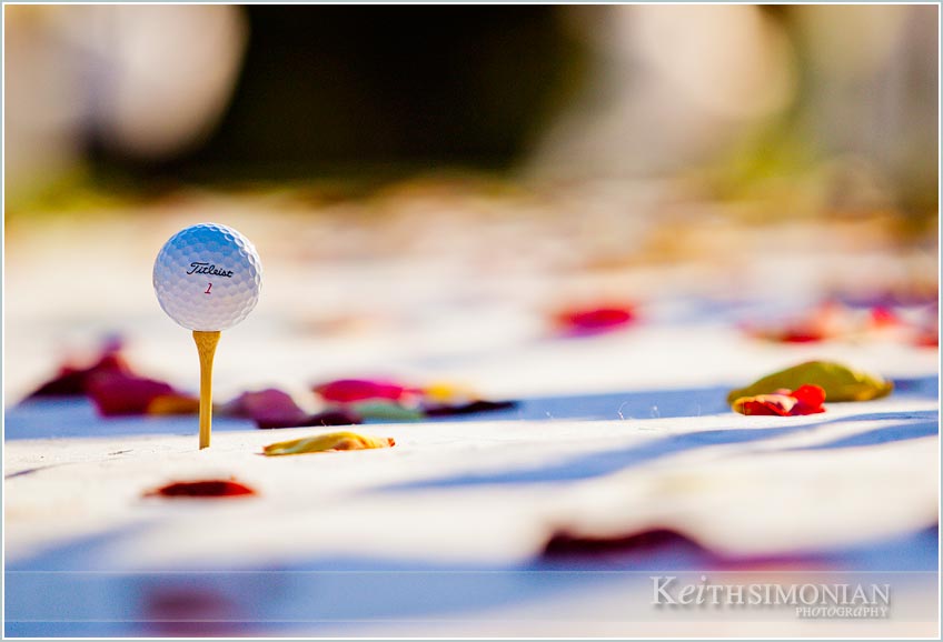 Titlest golf ball teed up with flower pedals on aisle