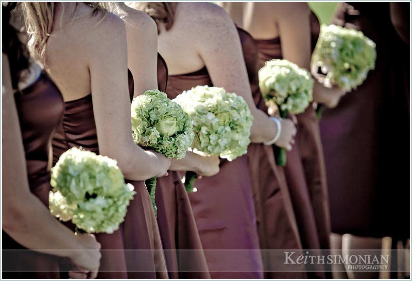 bridesmaids in brown dresses holding their flowers