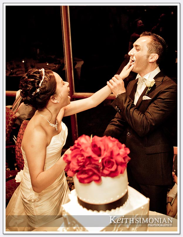 the bride and groom share cake during the cake cutting ceremony