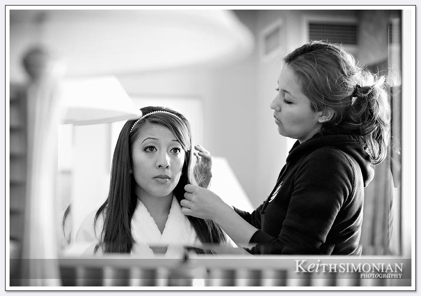 Black and white photo of bride having hair done at Hilton Hotel