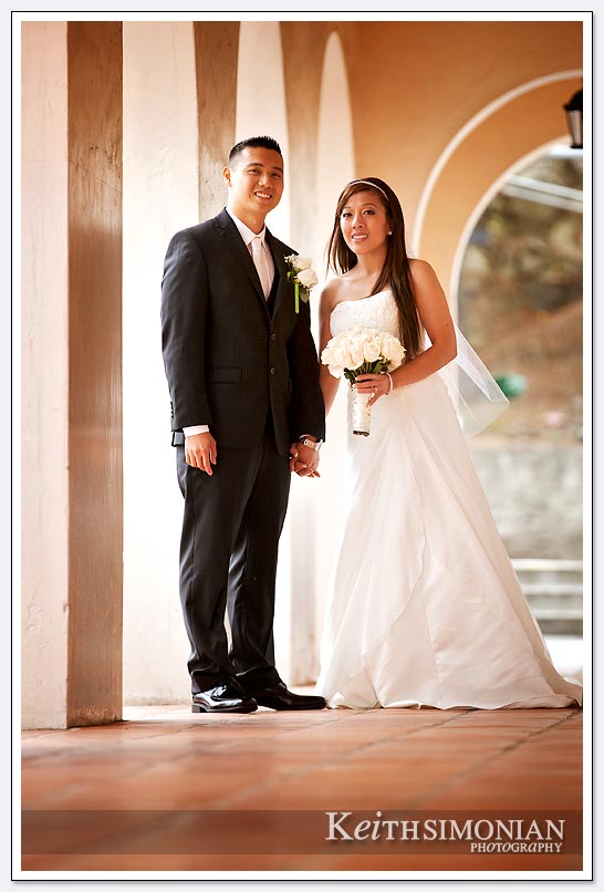 Bride with bouquet and her new husband pose for portrait