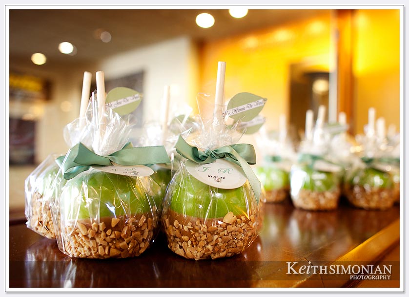 Green candy apples await the guests at the wedding reception
