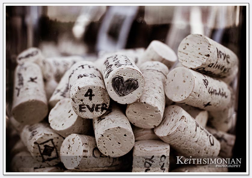 Vintage looking photo of wine bottle corks with drawings and messages from friends and family