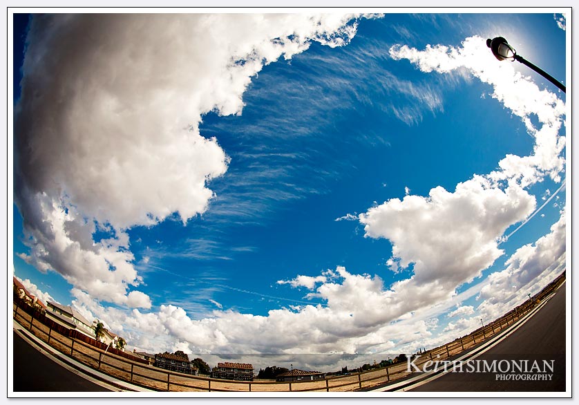 This sunny day with clouds is captured with a fisheye lens that gives the world a curved view