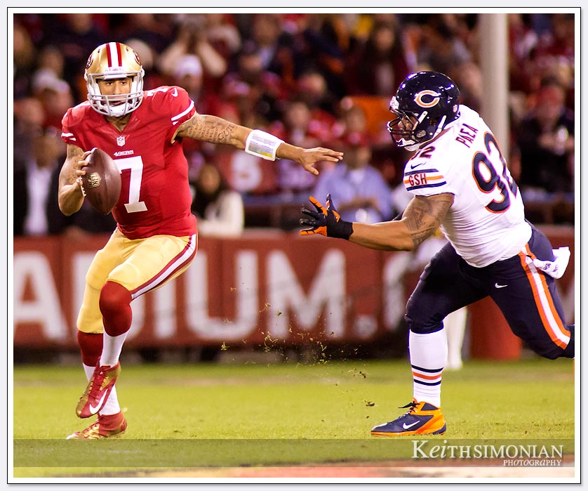 49er quarterback Colin Kaepernick eludes a Chicago Bear defender on Monday Night football - 11/19/2012