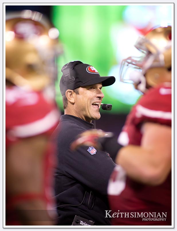 head coach Jim Harbaugh is all smiles after a San Francisco 49ers touchdown play