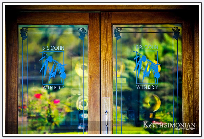 Flowers cast a reflection in the glass door of the B. R. Cohn winery in the Napa Valley