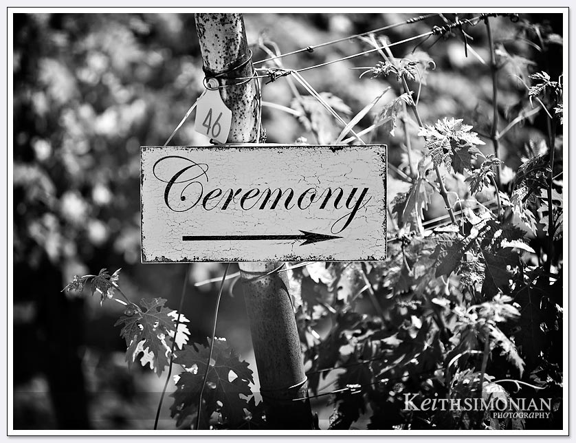Black and white photo of sign telling guests where the wedding ceremony is at the BR Cohn winery