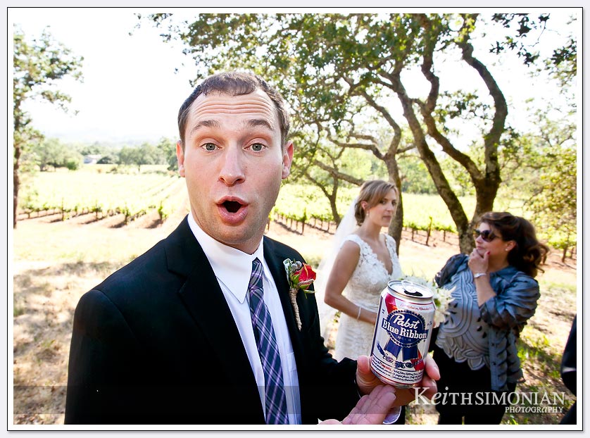 Groomsman holding can of Pabst Blue Ribbon beer at BR Cohn Winery in the Sonoma Valley