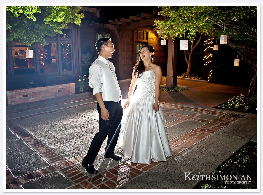 This night photo that used back lighting and front flash shows the bride and groom laughing at the Saratoga Foothill Club