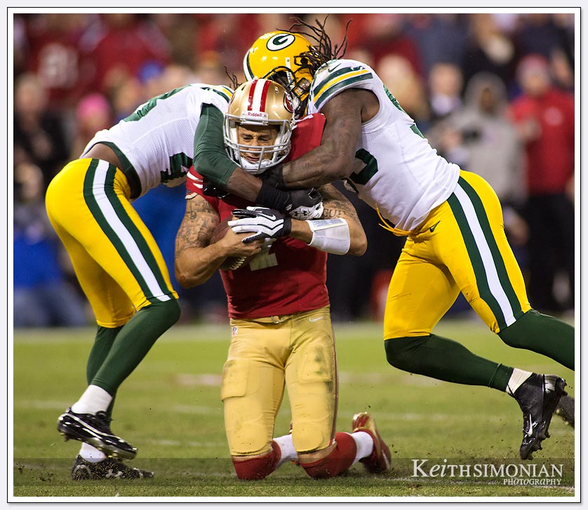 49ers quarterback Colin Kaepernick is double teamed by Green Bay Packer defenders