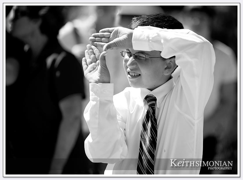 A young guest at the Oakland LDS wedding uses his hands to frame the shot