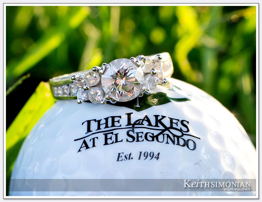 The brides engagement ring sits atop a golf ball from The Lakes at El Segundo golf course