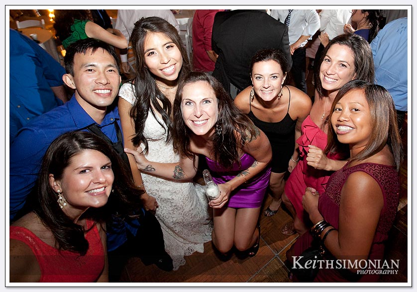 The bride and her friends pose for a photo on the dance floor at The Lakes at El Segundo