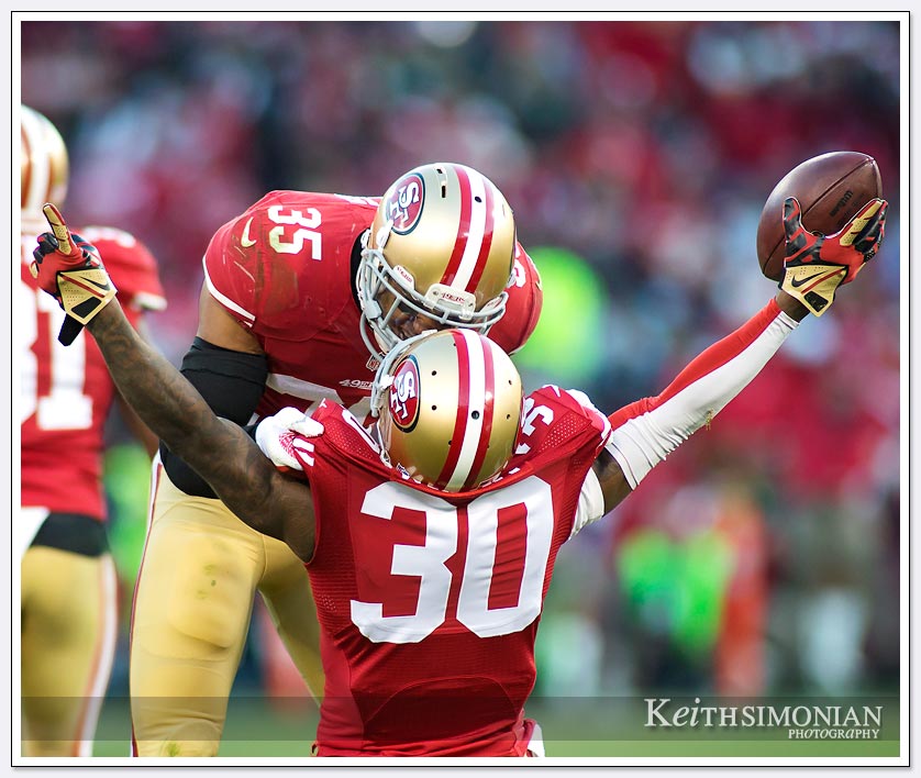 San Francisco 49er Eric Reid celebrates with Eric Wright over his game ending interception against the Seattle Seahawks on December 8, 2013 at Candlesick Park