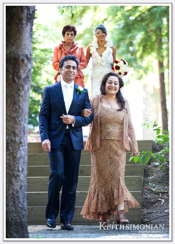 Bride and groom enter the Amphitheater of the Redwoods at the same time during this Persian wedding ceremony at Pema Osel Ling