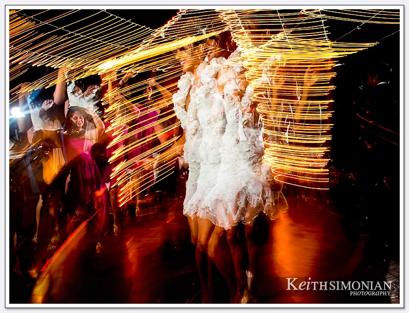 A nighttime wedding reception with the bride dancing at Pema Osel Ling.