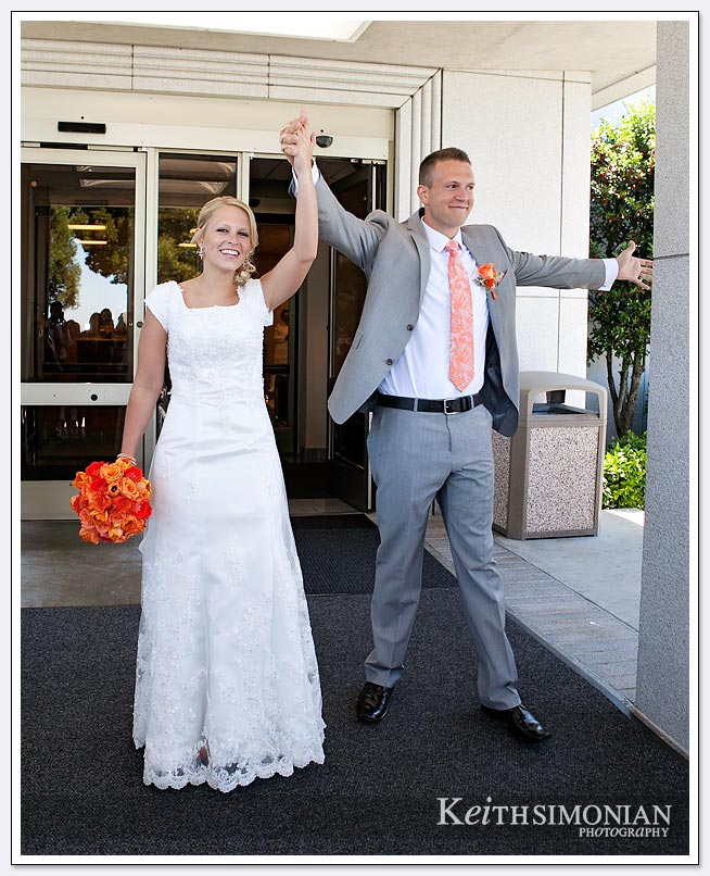 The bride and groom leave the Oakland LDS temple after just getting married
