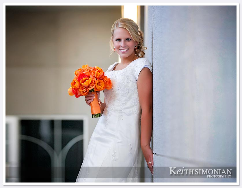 The bride poses with her bouquet outside the Oakland LDS temple