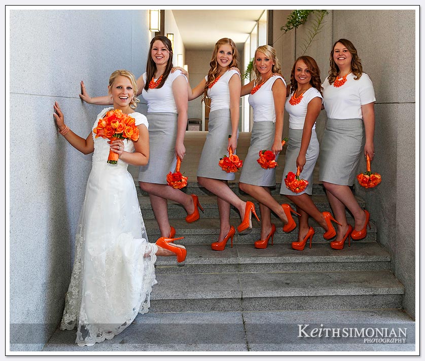 The bride and bridesmaid pose for photo outside Oakland LDS temple