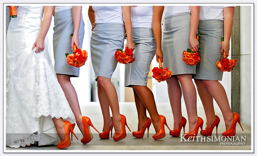 The bride and bridesmaids show off their orange high heel shoes outside the Oakland LDS temple