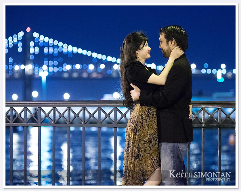 The lights glow from the Bay Bridge in the background - San-Francisco-Engagement-Photos